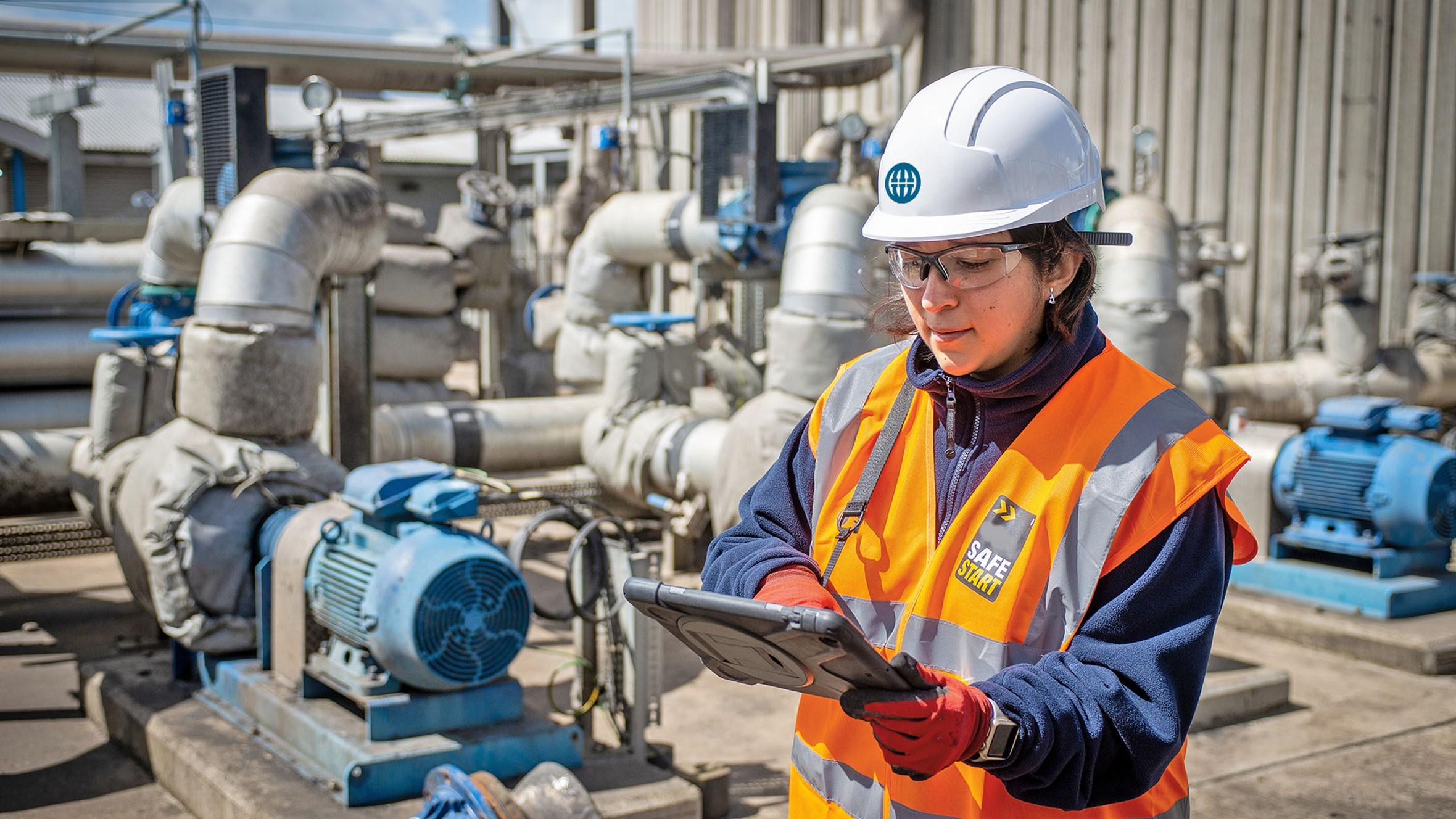 Image of a worker near pipes at a water treatment plant