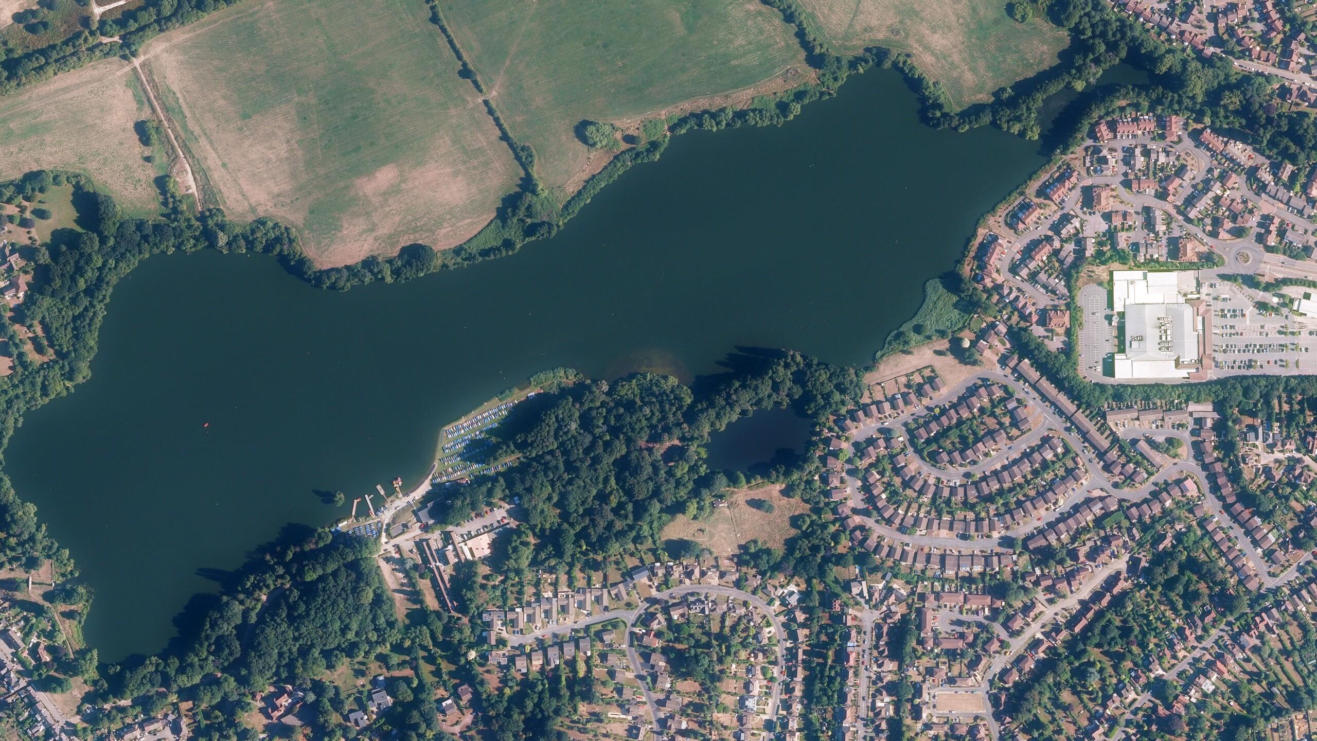 Aerial view of a residential area next to a lake and parkland