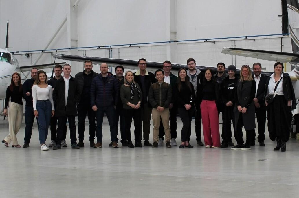 The Bluesky Team gathered under the wing of one of our aircraft in a hanger at our Birmingham Airport base.