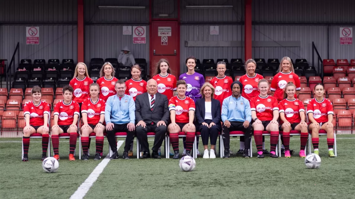 Tamworth womens football team and Bluesky CEO Rachel Tidmarsh being photographed on the pitch