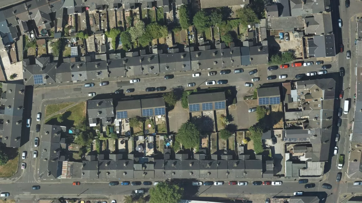 Aerial photograph showing an urban street with solar panels on the rooftops